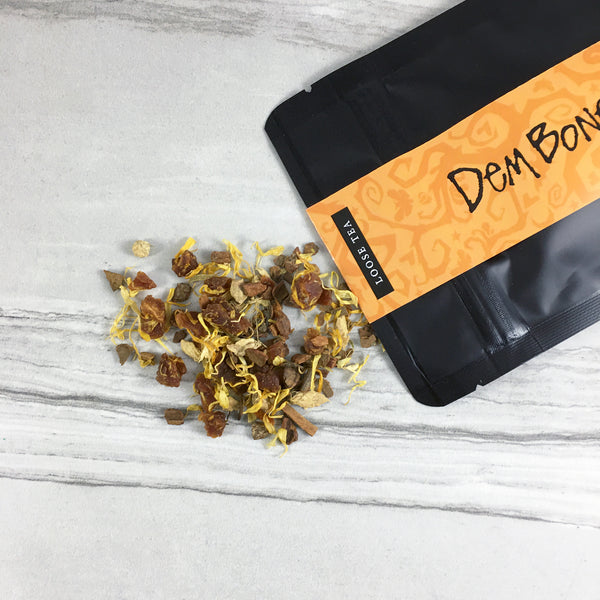 Black Bag of tea with Apricot Cinnamon Tea spilling out, Orange graphics bag with spooky vines, Loose Tea, DemBones Shoppe