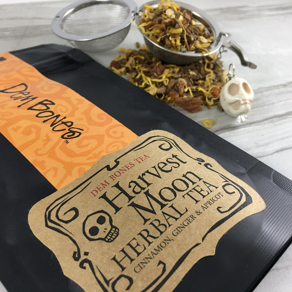 Close of of black bag of tea, DemBones Tea , Harvest Moon Herbal Te, a, Cinnamon Ginger and , Tea Infuser with Skull Bead